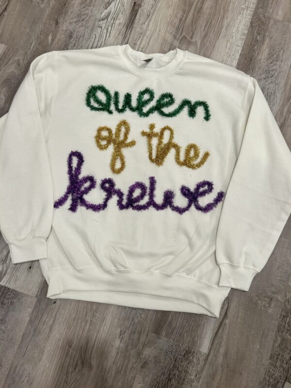 handcrafted white sweatshirt with Queen of the Krewe custom yarn work