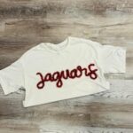 handcrafted white sweatshirt with Jaguars custom yarn work