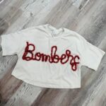 handcrafted white sweatshirt with Bombers custom yarn work